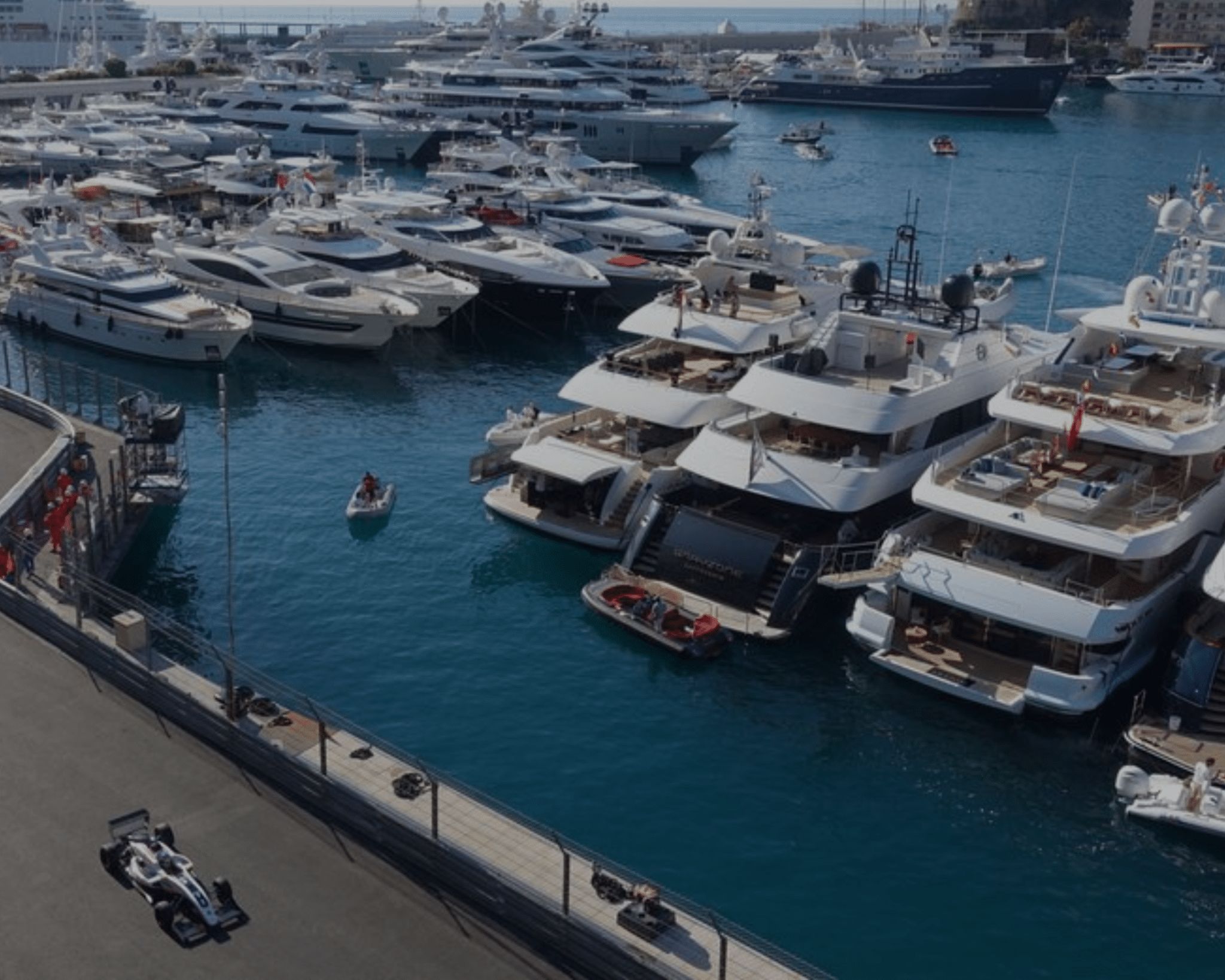 yachts moored up with racing cars going past